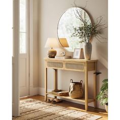 a wooden table topped with a mirror next to a lamp and potted plant on top of it