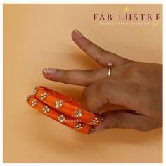 PRODUCT DETAILS: Product Code: AESB-2208-32 Color: Solid colours (Set of 2) Color Variants:  Fire Orange, Hot Pink, Indigo,Parakeet,Turquoise Material: Plastic, Bead and Silk Sizes: 2.6 & 2.8 (It is advisable to take 1-size larger than your regular bangle size) Dimension: 20 grams in weight (for 2 pieces) Description: Each set of bangles contains a set of 2 bangles of a single color. They are beautiful silk-thread bangles with a gold thread twined over it interspersed with gold bead embelishment. bangle is a single solid color. They add such an amazing touch to your outfit! It is great for stacking or layering, too. The bangle is made of plastic, hence is flexible and stress-resistant. Please message us for any further details.  Shipping: The shipping period varies from place to place. Shi Orange Silk Thread Bangles, Orange Bracelet For Festivals As Gift, Orange Bracelets As Festival Gifts, Orange Festival Bracelet As Gift, Orange Bracelets For Festivals Gift, Orange Bangle For Festivals, Orange Festival Bangle Jewelry, Handmade Adjustable Bracelets For Celebration, Adjustable Orange Bracelets For Weddings