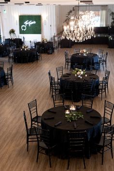 tables and chairs are set up for an event with chandelier hanging from the ceiling