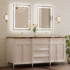 a bathroom with two sinks, mirrors and lights on the wall next to a potted plant