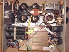 the inside of an electrical box with many wires and other items in it, including two speakers