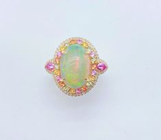 LAST CALL, LAST CHANCE LIQUIDATION SALE The Following Item we are offering is a Rare Important Radiant 18KT Gold Large Fancy Fiery White Opal Diamond Pink Sapphire Ring. Ring is comprised of A LARGE Gorgeous Fancy Fiery White Rainbow Opal surrounded by a Beautiful Halo of Fancy Rainbow Sapphires, surrounded with a Halo of Diamonds, and Pink Sapphire Baguettes on each side. T.C.W APPROX 8 CTS Comes with New with Tags from a Private Manufacturer that sells to Important 5 Star Hotel and Fine Jewelr Luxury Oval Rainbow Colored Ring, Luxury Oval Rainbow Rings, Luxury Iridescent Ring, Luxury Unique Opal Ring With Diamond, Luxury Multicolor Unique Opal Ring, Luxury Oval Rainbow Ring, Luxury Fine Jewelry Opal Ring For Women, Luxury Heirloom Opal Ring, Rainbow Diamond Wedding Ring