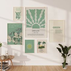 a room with posters on the wall and a potted plant in front of it