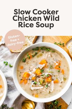 a bowl of slow cooker chicken wild rice soup on a cutting board with bread