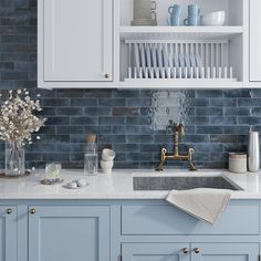 a kitchen with blue cabinets and white cupboards, an open shelf above the sink