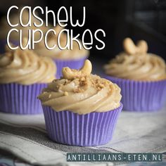 three cupcakes with peanut butter frosting on top and the words cashewnoten cupcakes above them