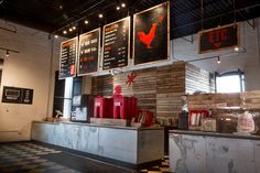 the interior of a restaurant with menus hanging on the wall