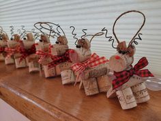 several wine corks are arranged in the shape of reindeer heads with red and black bows