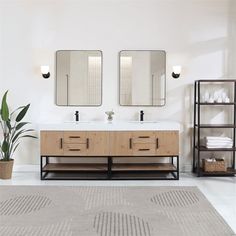 a bathroom with two sinks and mirrors on the wall