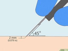 a pair of scissors cutting through the side of a piece of paper with a ruler