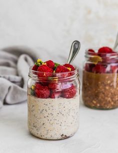 two mason jars filled with chia seed pudding and raspberries on the side