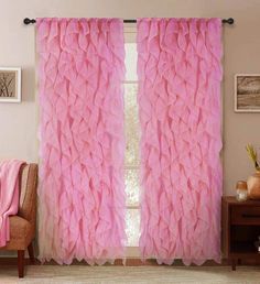 pink ruffled curtains in a living room