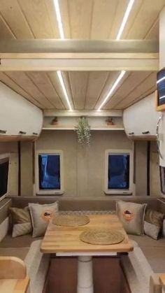 the inside of an rv with couches and tables