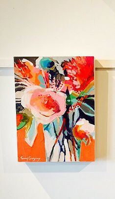 two paintings hanging on the wall next to each other, one has an orange vase with flowers in it