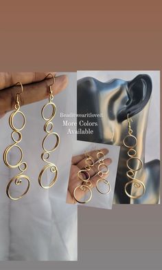 the earrings are being held up to show them in different positions and shapes, including spirals