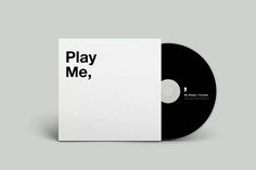 a black and white cd with the words play me, on it