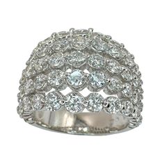 a white gold ring with diamonds on the sides and an oval design in the middle