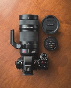 a camera lens sitting on top of a wooden table