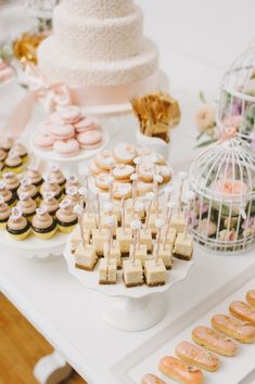 a table topped with lots of cupcakes and cakes