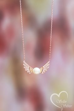 This product, which we designed by combining the nobility of the angel and the elegance of the pearl, will make you or your loved ones feel special. Gift-ready, high-quality, elegant silver pendant necklace to wear in all sorts of occasions. Buy it for yourself or as a special gift for your loved one, family or friends. Special pearl is used in this product. You can always contact us.; I will be happy to help with any requests or questions. FOR GIFT: We send all your orders in our elegant gift-r Elegant Wing-shaped Jewelry As Gift, Elegant Wing-shaped Jewelry Gift, Elegant Angel Wings Necklaces, Elegant Angel Wings Jewelry, Elegant Gold Angel Wings Necklace, Elegant Gold Necklace With Angel Wings, Dainty Pearl Necklace, Necklace With Pearl, Angel Wing Necklace