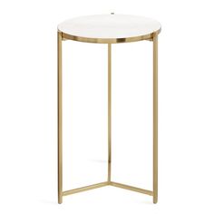 a white and gold side table with a round marble top on an isolated metal stand