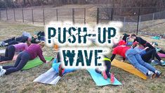 a group of people doing push up on yoga mats in a park with the words push - up wave over them