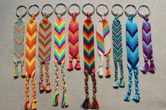 six different colored braided key chains with tassels hanging from each one's side