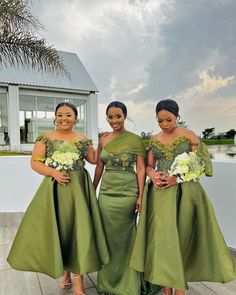 three women in green dresses posing for the camera