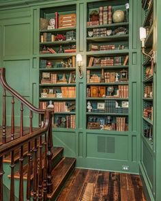 the bookshelves are full of many different types of books in this green room