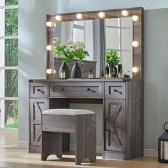 a wooden vanity with lights on it and a stool in front of the mirror that is lit up