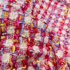 a close up of a person's hand holding a piece of fabric that has been crocheted