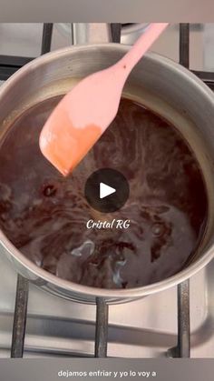 a pan filled with chocolate sitting on top of a stove