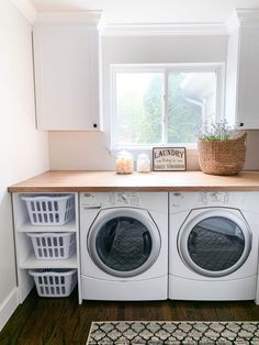 a washer and dryer in a laundry room next to a window with a sign on it