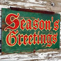 a green and red sign that says season's greetings