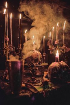 a table topped with lots of candles and skulls