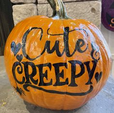 a pumpkin with the words cutie creepy painted on it