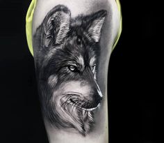 a black and white tattoo of a wolf