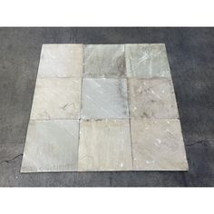 a tile floor that has been laid out on top of it with different colors and shapes