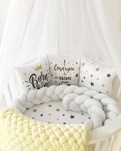 a crocheted blanket and pillows on a bed