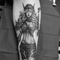 black and white photo of a woman's leg with tattoos on it