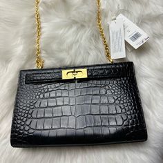 Tory Burch ‘Lee Radziwill’ Shoulder Bag New Never Used Tag Was Removed From The Bag Black ‘Lee Radziwill’ Shoulder Bag From Tory Burch. Crafted From Patent Leather With A Crocodile Skin Effect Throughout, This Design Features Distinctive Fastener, A Half-Round Handle, A Detachable And Adjustable Shoulder Strap And Interior With One Compartment. 100% Leather Height: 16cm Width: 26cm Elegant Evening Bags With Cc Turnlock Closure, Elegant Crossbody Satchel With Cc Turnlock Closure, Elegant Black Satchel With Cc Turnlock Closure, Elegant Shoulder Bag With Cc Turnlock Closure, Classic Shoulder Bag With Turn-lock Closure For Shopping, Formal Clutch Bag With Turn-lock Closure, Formal Black Satchel With Cc Turnlock Closure, Shoulder Bag With Turn-lock Closure, Turn-lock Closure Shoulder Bag For Shopping