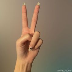 a woman's hand making the peace sign with her fingers