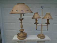 two lamps sitting on top of a table next to a garage door