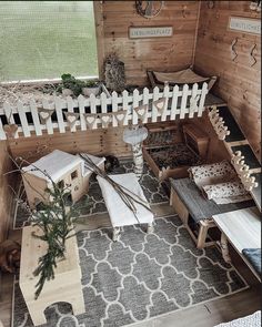 an overhead view of a dollhouse with furniture and decorations on the floor in front of a wooden fence