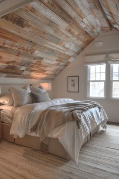 a bed sitting under a wooden ceiling in a bedroom