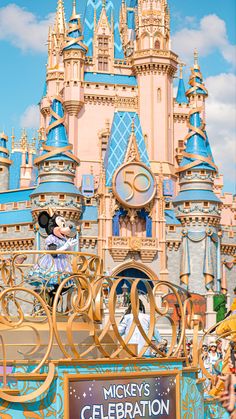 mickey's celebration parade in front of the castle at disney world, with minnie mouse on top