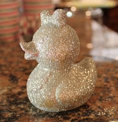 a silver glittered rubber duck sitting on top of a counter