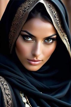 a woman with blue eyes wearing a black shawl