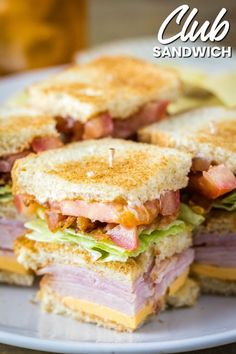 a cut in half sandwich sitting on top of a wooden cutting board