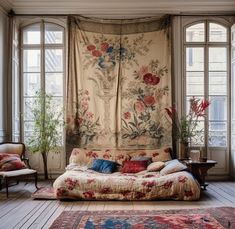 a living room filled with lots of furniture and flowers on the wall hanging from the ceiling